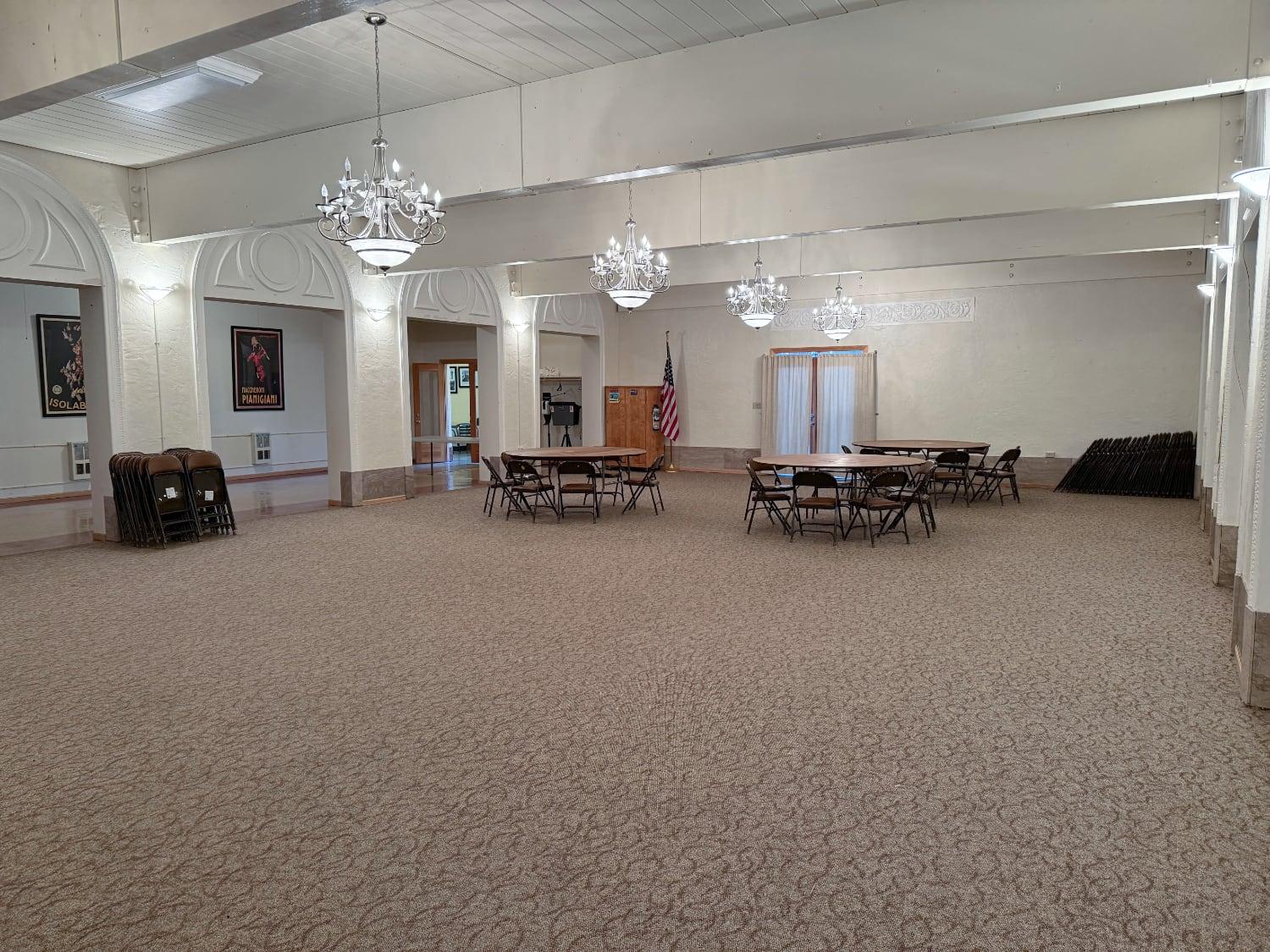 Ballroom with round tables and chandeliers